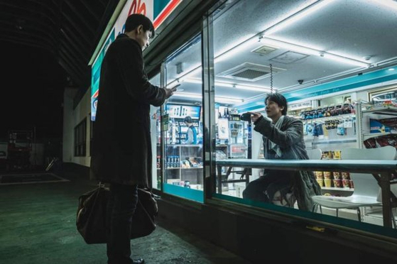 Kim Nam-gil, right, and Jung Woo-sung, left, each play Woo-jin, a contract killer, and Soo-hyuk, the man Woo-jin chases down, in the new noir film ″A Man of Reason″ [ACEMAKER MOVIEWORKS]