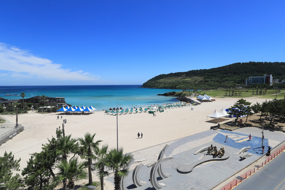 Hamdeok Beach in Jeju City, Jeju is loved for its clear waters and palm trees [YONHAP]