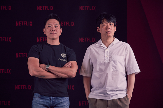 Producers Moon Sang-don, left, and Park Jin-kyung, right, behind the new Netflix reality television show ″Zombieverse″ [NETFLIX]