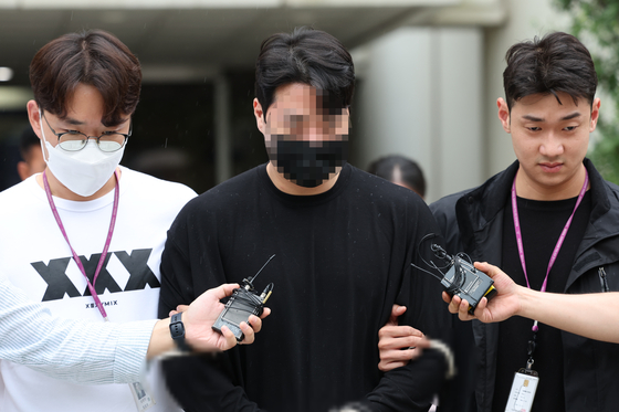 Shin Woo-jun, 28, accused of hitting a woman while driving under the influence of drugs near Apgujeong Station in southern Seoul earlier in the month, leaves Seoul Central District Court after attending an arrest warrant hearing on Saturday. [YONHAP] 