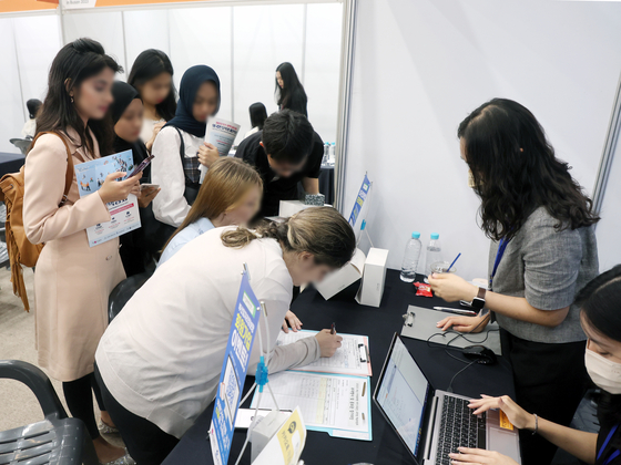 International students line up at a booth at a job fair in Busan on July 20. [YONHAP] 