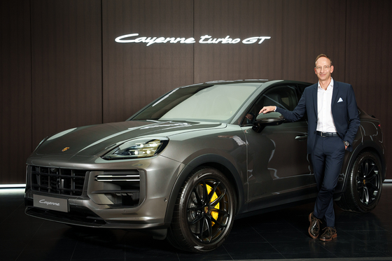 Porsche Korea CEO Holger Gerrmann poses with the Cayenne Turbo GT on Thursday. [PORSCHE KOREA]
