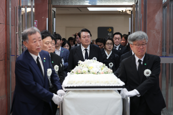President Yoon Suk Yeol, center, takes part in a funeral procession for his father, Yoon Ki-jung, at Severance Hospital Seodaemun District, western Seoul, Thursday morning. The late Yonsei University professor was later buried in a cemetery in Gyeonggi. [PRESIDENTIAL OFFICE]