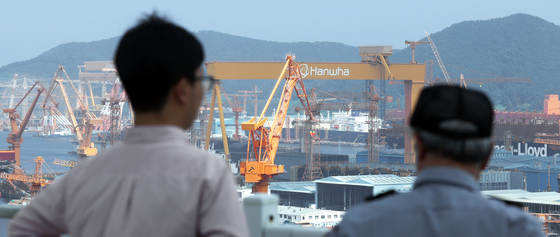 A fresh nameplate reading "Hanwha Ocean" is visible on a large crane at the company's shipyard in Geoje, South Gyeongsang, on Tuesday, following the rebranding of Korean shipbuilder Daewoo Shipbuilding & Marine Engineering as Hanwha Ocean in May. [YONHAP]
