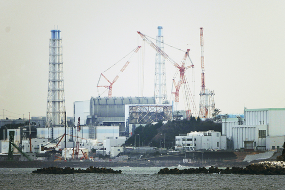 The Fukushima Daiichi nuclear power plant sits in coastal towns of both Okuma and Futaba, as seen from the Ukedo fishing port in Namie, Fukushima Prefecture, in northeastern Japan, on March 2, 2022. [AP/YONHAP]