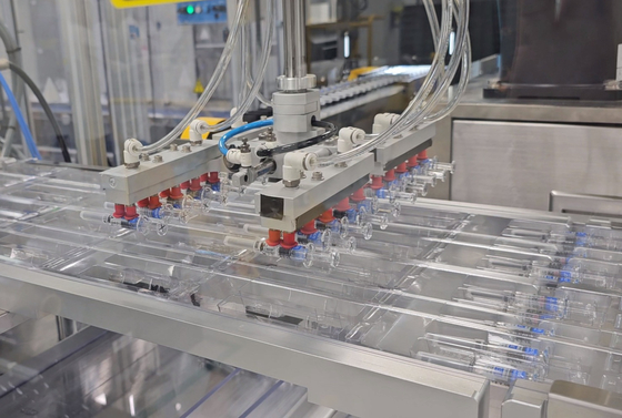 Pre-filled syringes of SKYCellflu influenza vaccine on the packaging line at SK bioscience’s Andong L House manufacturing plant in North Gyeongsang on Tuesday [SHIN HA-NEE]