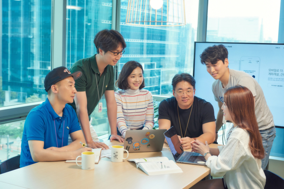 KakaoBank employees Barry, Charlie, Chloe, Bernard, Louis and Elly exchange opinions at the company's office in Pangyo, Gyeonggi [KAKAOBANK]