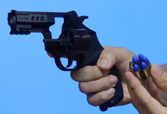 SNT Motiv's handgun with plastic bullets that are less lethal. [YONHAP]
