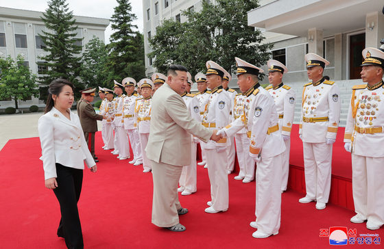 North Korean leader Kim Jong-un greets North Korean navy officers at the regime's naval headquarters in Pyongsong, South Pyongan Province, in this photograph release by the state-controlled Korean Central News Agency. His daughter Kim Ju-ae stands to the left. [YONHAP]
