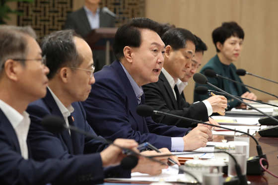 President Yoon Suk Yeol, center, speaks at an economic meeting at the Yongsan presidential office in central Seoul Thursday. [JOINT PRESS CORPS]