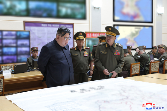 In this photo released on Thursday by Pyongyang's state-controlled Korean Central News Agency, regime leader Kim Jong-un reviews the North's war plans during his visit to a command post of the Korean People's Army on Tuesday. [YONHAP]