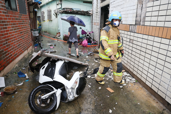 A motorcycle near the closed-down public bathhouse in Busan knocked to the ground due to the explosions [YONHAP] 