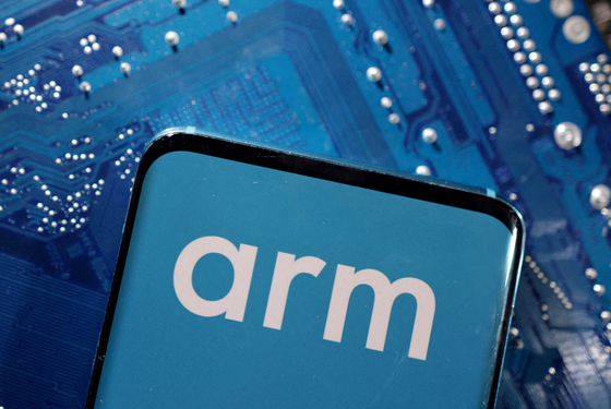 A smartphone with a displayed Arm Ltd logo is placed on a computer motherboard in this illustration taken March 6, 2023. [REUTERS]