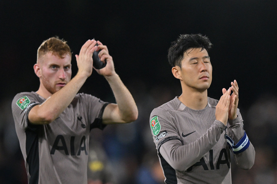 Tottenham Hotspur's Son Heung-min, right, and Dejan Kulusevski applaud at the end of a Carabao Cup match between Fulham and Tottenham at Craven Cottage in London on Tuesday. [AFP/YONHAP]