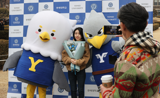 A Yonsei University first-year student poses for a photo during the university's matriculation ceremony in February 2023. [YONHAP]