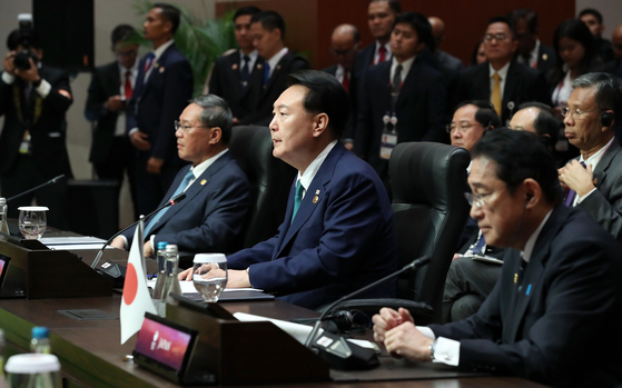 From left, Chinese Premier Li Qiang, Korean President Yoon Suk Yeol and Japanese Prime Minister Kishida Fumio attend the Asean Plus Three Summit held at the Balai Sidang Jakarta Convention Center in Indonesia Wednesday. [JOINT PRESS CORPS]