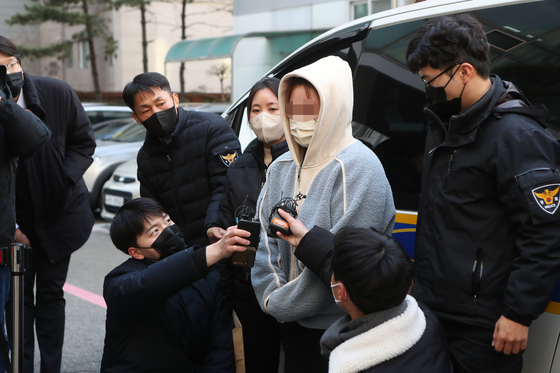 The 35-year-old mother, who hid the corpse of her 15-month-old daughter in a plastic container since 2020, being arrested by the Pocheon police in December 2022. [YONHAP]