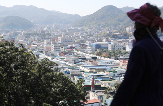 A person looks down on the old downtown in Gongju, South Chungcheong, from a mountain on Oct. 18, 2021. [YONHAP] 