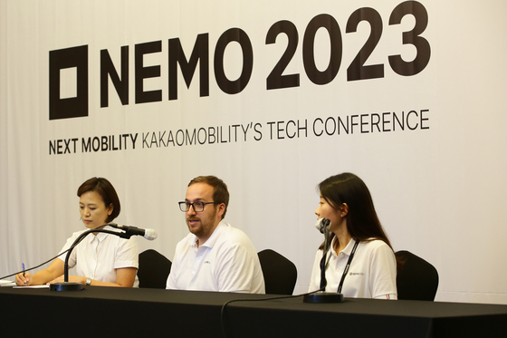 Splyt CEO Philipp Mintchin, center, with his translator, left, and Cho Hye-won, the head of Kakao Mobility’s global business planning, at a roundtable press event to introduce Kakao Mobility’s global strategy in southern Seoul on Friday. [KAKAO MOBILITY]