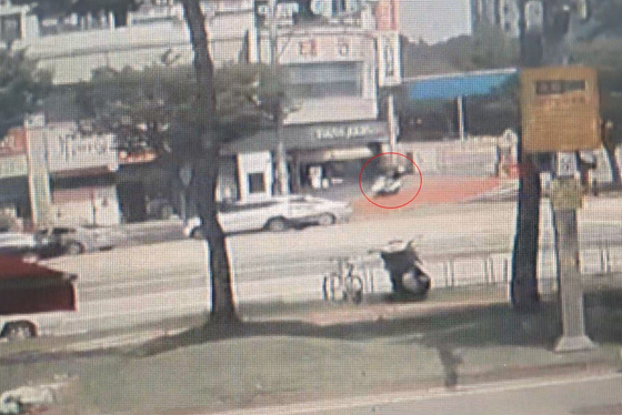 A CCTV footage shows the bank robber arriving on a motorcycle ahead of his heist of the National Credit Union Federation of Korea (Shinhyup) branch in Gwanjeo-dong, Seo-District in Daejeon around noon on Aug. 18. [YONHAP]