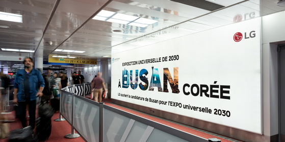 LG Corporation's promotional poster in support of Busan's bid to host World Expo 2030, displayed at Paris Charles de Gaulle Airport on Monday. LG is actively promoting Busan's bid for the World Expo in major cities worldwide, including New York, London, and Paris. [LG CORPORATION]