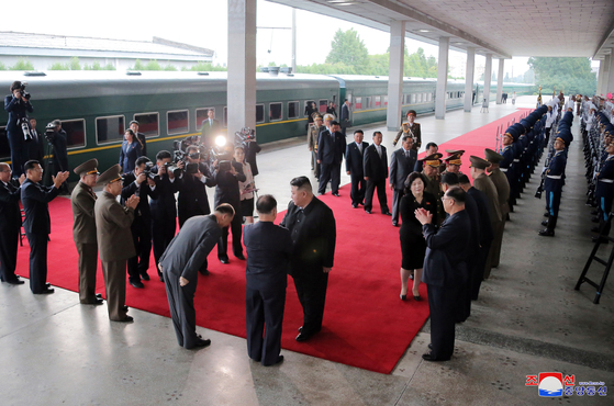 North Korean leader Kim Jong-un greets senior officials in Pyongyang before boarding a train to head to Russia Sunday afternoon in a photo released by the state-run Korean Central News Agency Tuesday. [YONHAP] 