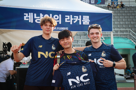 Seoul E-Land football fans pose in E-Land jerseys at Mokdong Sports Complex Main Stadium in western Seoul in August.  [SEOUL E-LAND]