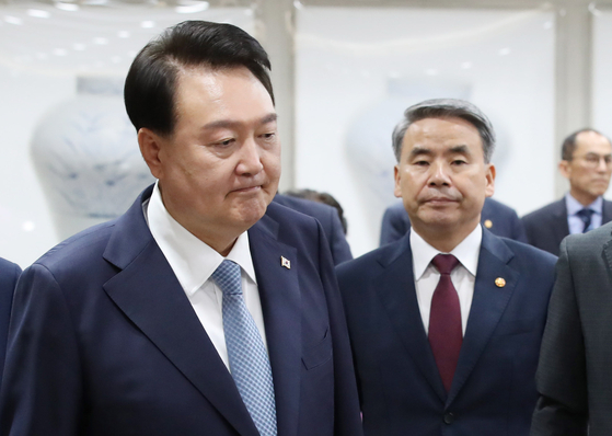 President Yoon Suk Yeol, left, and Defense Minister Lee Jong-sup, right, enter a Cabinet meeting Tuesday at the Yongsan presidential office in central Seoul. Lee offered to resign amid the Democratic Party’s calls to impeach him over the military’s alleged handling of an investigation into the death of a Marine corporal. [JOINT PRESS CORPS]