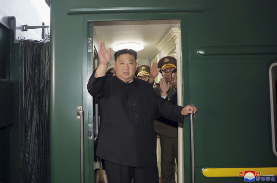 North Korean leader Kim Jong-un waves before departing on his armored train to head to Russia Sunday for a meeting with Russian President Vladimir Putin, as seen in a photo released by the state-run Korean Central News Agency Tuesday. [YONHAP]