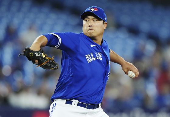Toronto Blue Jays starting pitcher Ryu Hyun-jin works against the Texas Rangers during the first inning of a game at Rogers Centre in Toronto on Tuesday. Ryu gave up three runs on five hits in six innings of work, earning his third loss of the season and pushing his ERA to 2.93.  [AP/YONHAP]