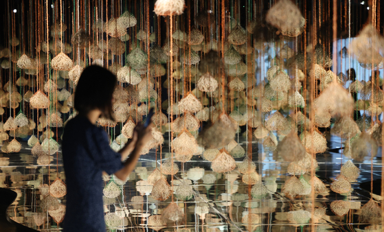 A visitor walks past "Love Song in the Forest" by Yoo Joung-hye at the 13th edition of the Cheongju Craft Biennale on Aug. 29. [YONHAP]