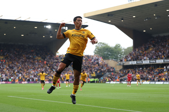 Wolverhampton Wanderers' Hwang Hee-chan celebrates after scoring the opening goal of a Premier League match against Liverpool at the Molineux in Wolverhampton, England on Saturday.  [AFP/YONHAP]
