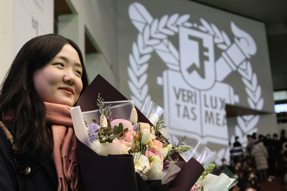 A first-year student at Seoul National University attend the matriculation ceremony in March. [YONHAP]