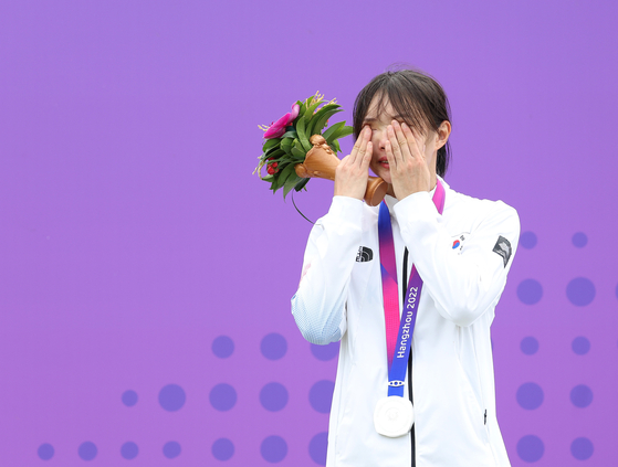 Kim Sun-woo reacts on the podium after winning silver in the women's individual modern pentathlon at the Hangzhou Asian Games in Hangzhou, China on Sunday. Kim's medal was Korea's first of the tournament.  [YONHAP]