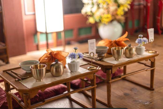 Korean traditional tableware are placed on wooden dining tables. [CULTURAL HERITAGE ADMINISTRATION] 