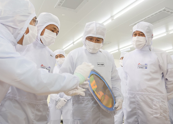 Finance Minister Choo Kyung-ho, center, visits SK hynix's chip manufacturing facility in Icheon on Wednesday. [MINISTRY OF ECONOMY AND FINANCE]