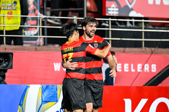 The Pohang Steelers' Zeca, right, celebrates with Hong Yun-sang after scoring a goal against the Wuhan Three Towns during an AFC Champions League group stage match at Pohang Steelyard in Pohang, North Gyeongsang on Wednesday. [AFC]