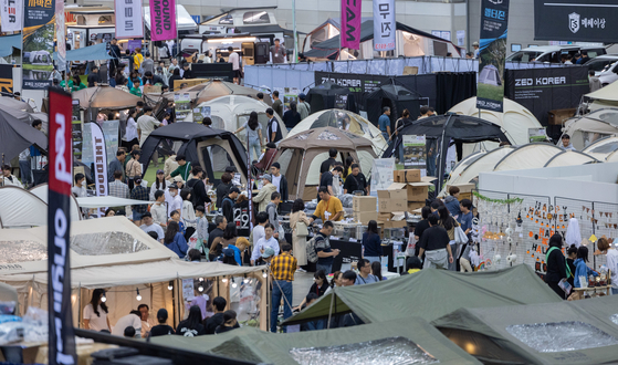 Visitors look through a variety of camping gear at the 2023 Global Outdoor Camping & Leisure Sports Fair held in Kintex in Goyang, Gyeonggi, on Sunday. [NEWS1]