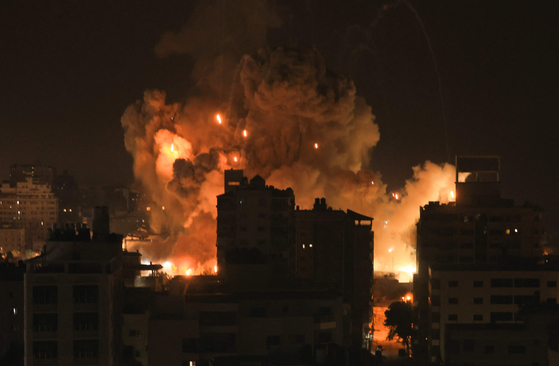 Fire and smoke rise above buildings in Gaza City during an Israeli air strike on October 8, 2023. Israel, reeling from the deadliest attack on its territory in half a century, formally declared war on Hamas Sunday as the conflict's death toll surged close to 1,000 after the Palestinian militant group launched a massive surprise assault from Gaza. [AFP/YONHAP]