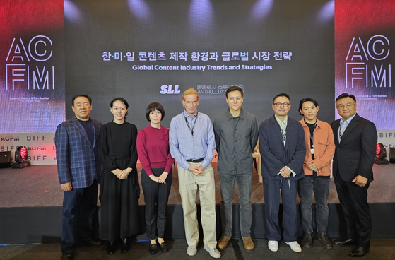 Attendees at the Asian Contents & Film Market 2023, including SLL JoongAng CEO Jung Kyung-moon, pose for a photo at the Busan Exhibition and Convention Center in Busan on Monday. [SLL JOONGANG] 