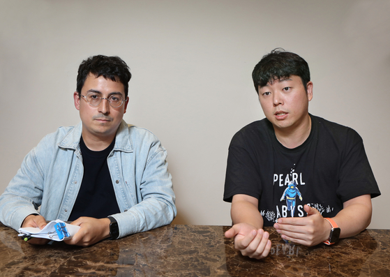 Head of Pearl Abyss's localization center, Joseph Yoon, right, and Bernardo Vidal, a project lead at the center, talk during an interview with the Korea JoongAng Daily. [PARK SANG-MOON]