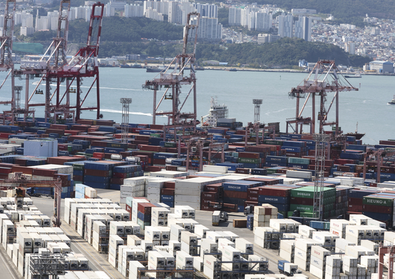 Containers are unloaded at a port in Busan on Wednesday. [YONHAP]