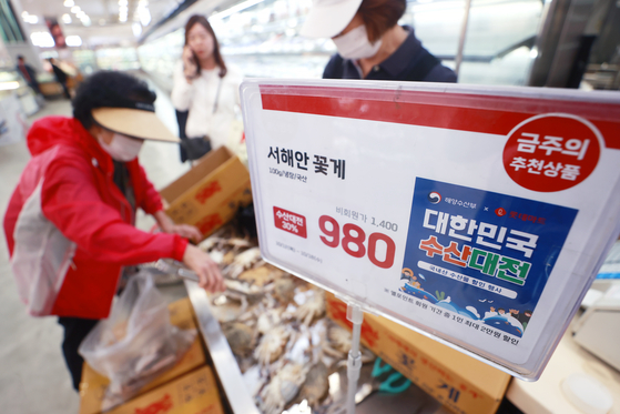 Shoppers select seafood products at a large supermarket in Seoul on Thursday. The Ministry of Oceans and Fisheries is hosting a major promotion for domestic fisheries products through Oct. 29, with discounts of up to 60 percent at online and offline marts. [YONHAP]