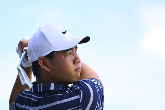 Tom Kim, also known as Kim Joo-hyung, watches his ball on the range prior to the FedEx St. Jude Championship at TPC Southwind on in Memphis on Aug. 8.  [PGA TOUR]