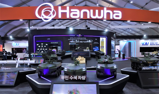 Unmanned search vehicles, center, and the Arion-SMET unmanned ground vehicle, right, are exhibited at Hanwha Group's show space at the Seoul International Aerospace & Defense Exhibition in Seongnam, Gyeonggi, on Monday. [HANWHA AEROSPACE]