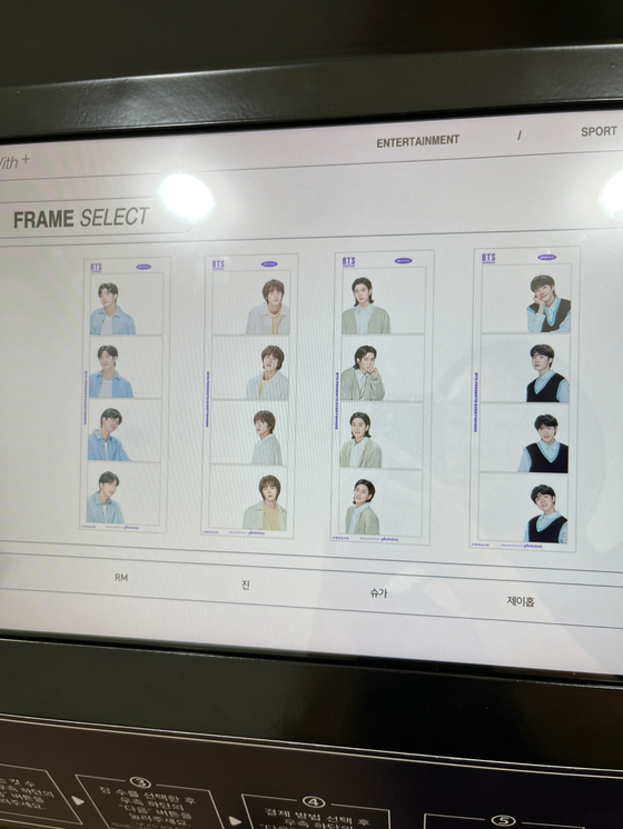 A Photoism booth in Sinchon offers “Artist Frames,″ which allow users to take a photo with BTS members as if they are right next to them using specially designed photo frames. [CHLOE PUI YING SAVANNAH YU] 