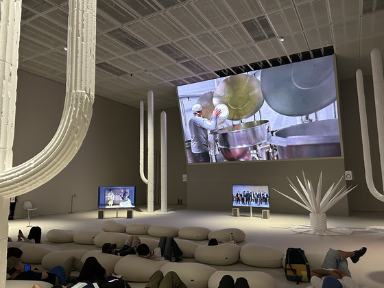 Visitors sit on beanbags and watch Jung Yeon-doo's video installation piece ″One Hundred Years of Travels″ (2023) at the National Museum of Modern and Contemporary Art Seoul in Jongno District, central Seoul, on Sept. 27. [SHIN MIN-HEE]