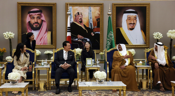 Korean President Yoon Suk Yeol second from left, speaks with Prince Mohammed bin Abdulrahman bin Abdulaziz, second from right, after arriving with first lady Kim Keon Hee, left, at King Khalid International Airport in Riyadh, Saudi Arabia, Saturday. [JOINT PRESS CORPS]