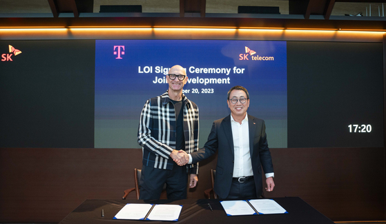 Deutsche Telekom CEO Tim Höttges and SK Telecom CEO Ryu Young-sang pose for a photo after signing a partnership to codevelop a multilingual large language model at SK Telecom headquarters in Jung District, central Seoul, on Friday. [SK TELECOM]