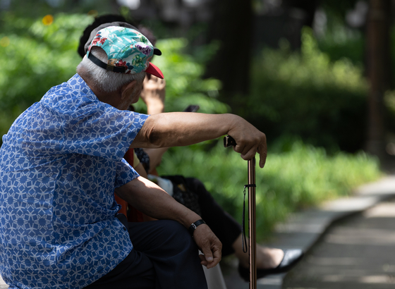 An old man takes a rest in the Tapgol Park in central Seoul on July 25. [NEWS1]